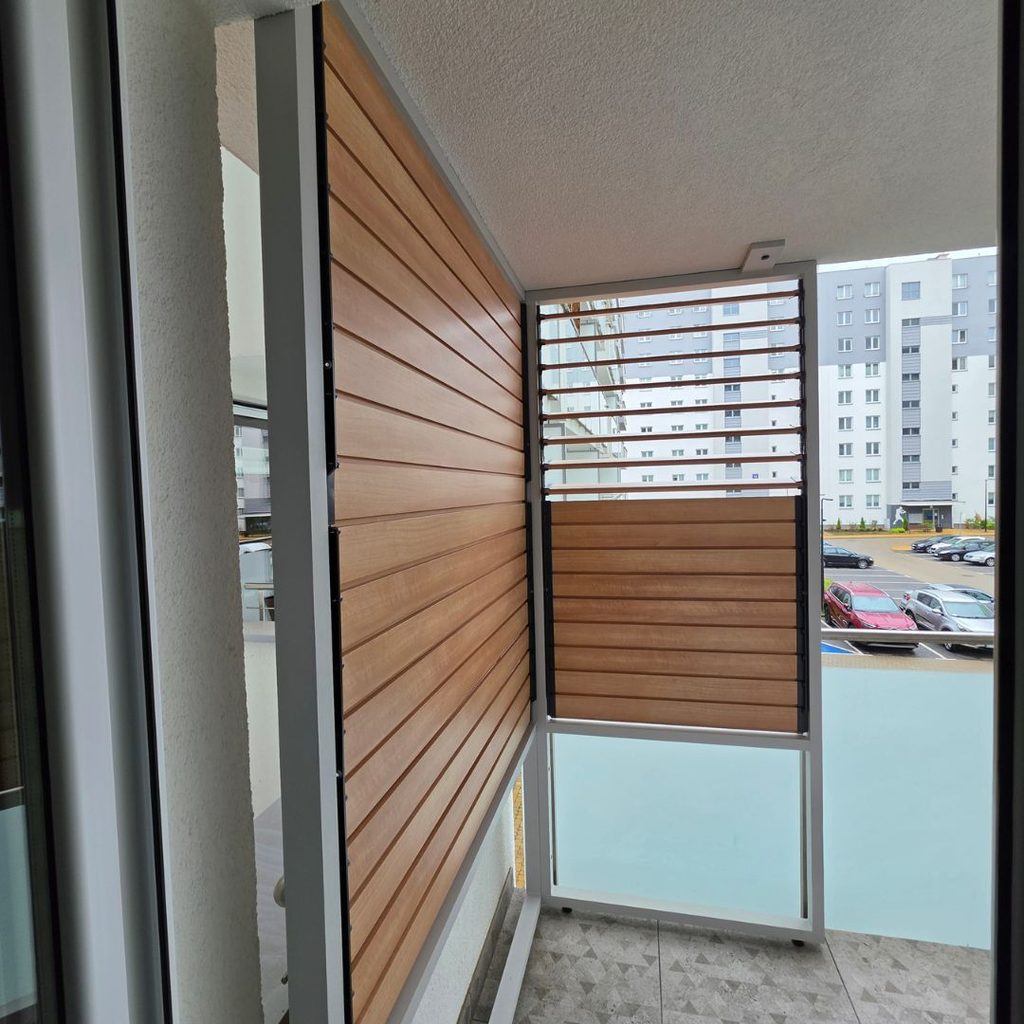 Balcony enclosure in a block of flats, extending from the balustrade to the ceiling with OpenUp System retractable patio blinds